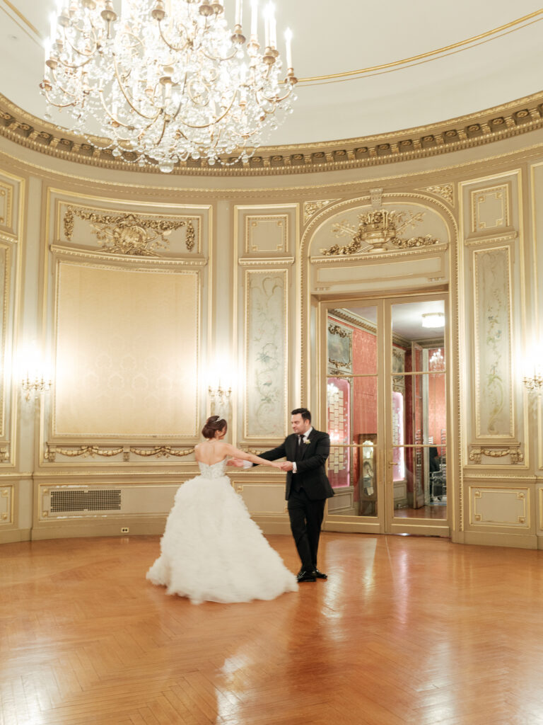 A couple dances in the ballroom of the Perry Belmont House