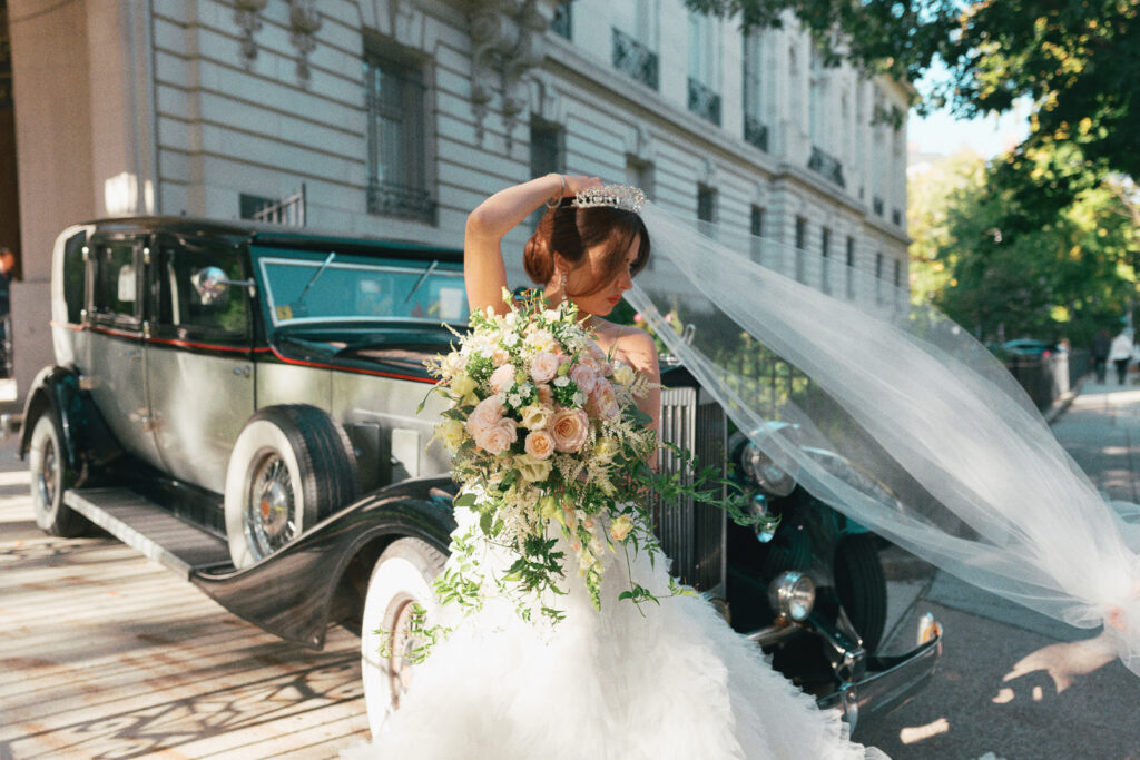 A bride stands in front of the Perry Belmont House in Washington DC