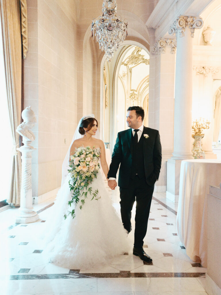 A couple walk through the halls of the Perry Belmont House