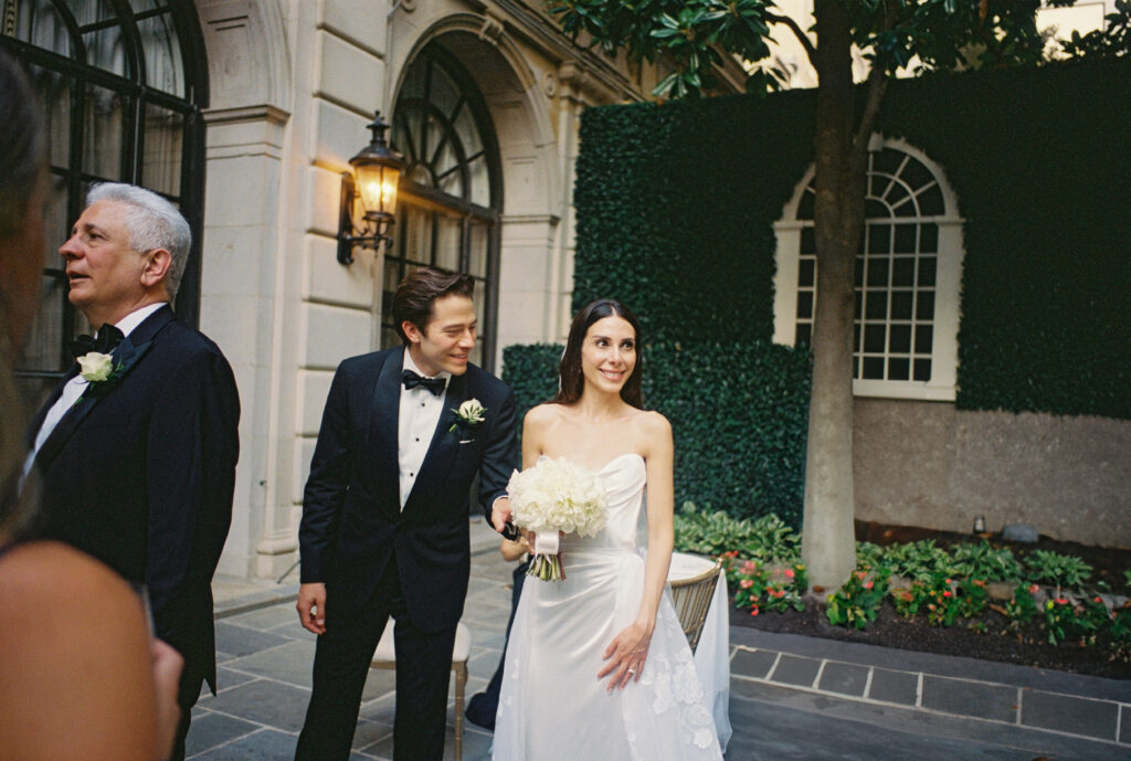 A wedding couple smiles at the St. Regis Hotel in Washington, DC