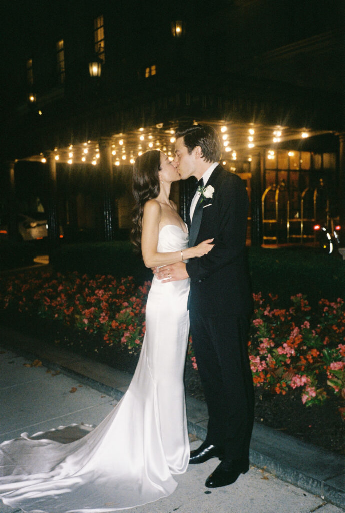 A wedding couple kisses at the St. Regis Hotel in Washington, DC