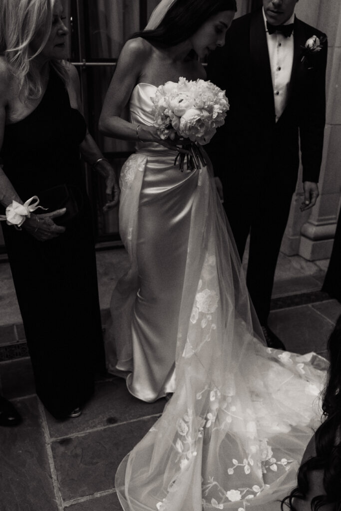 A bride fixes her dress at the St. Regis Hotel in Washington, DC