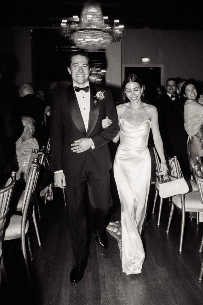 A wedding couple enter their reception at the St. Regis Hotel in Washington, DC