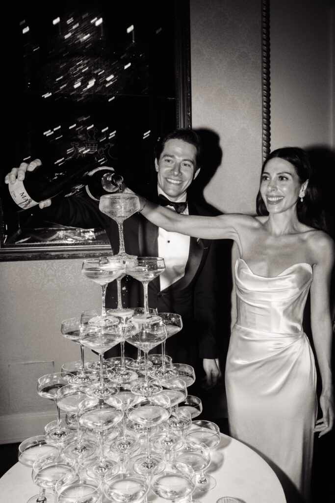 A wedding couple pours champagne at the St. Regis Hotel in Washington, DC 