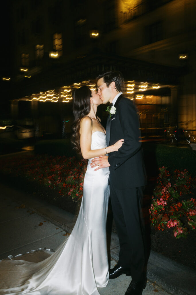 A wedding couple kisses at the St. Regis Hotel in Washington, DC