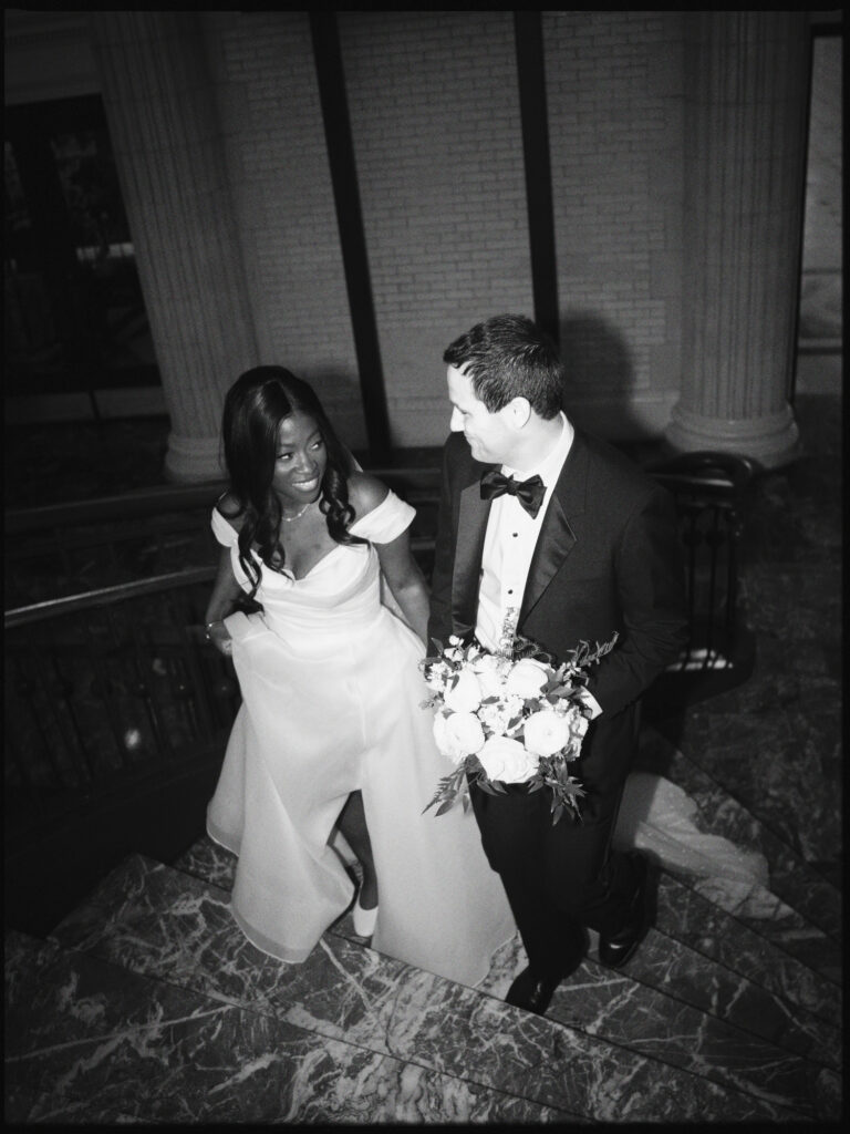 A Union Station wedding couple walks up the stairway in Washington DC