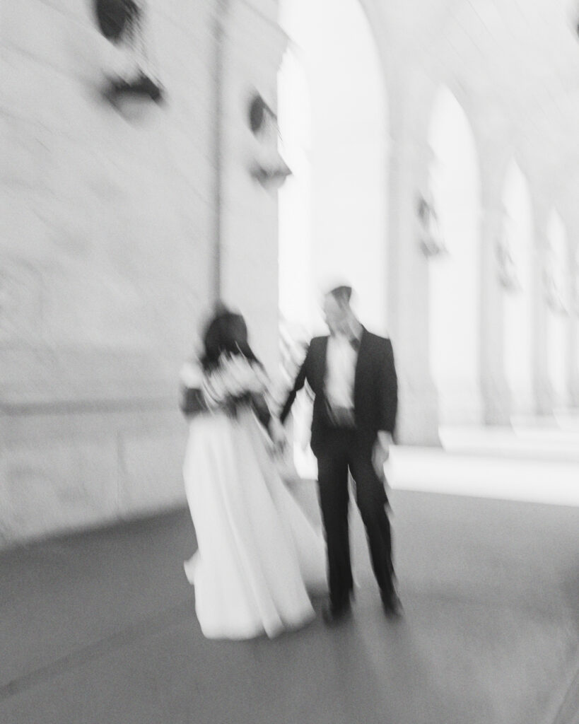 A Union Station wedding couple poses in front of their ceremony in Washington DC