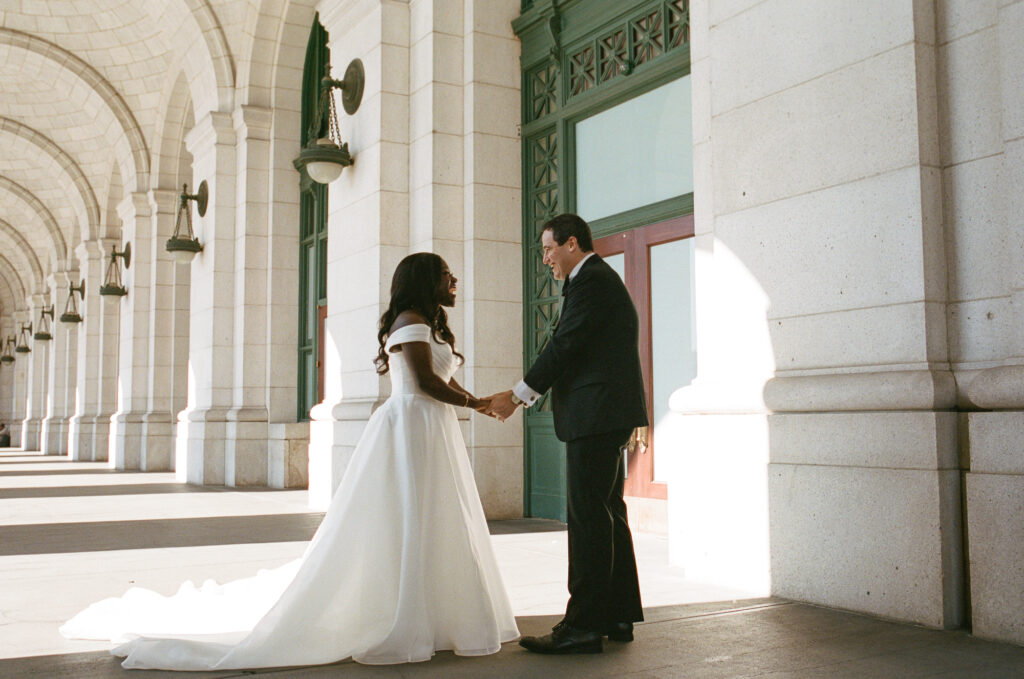 A Union Station wedding couple hold hands in Washington DC